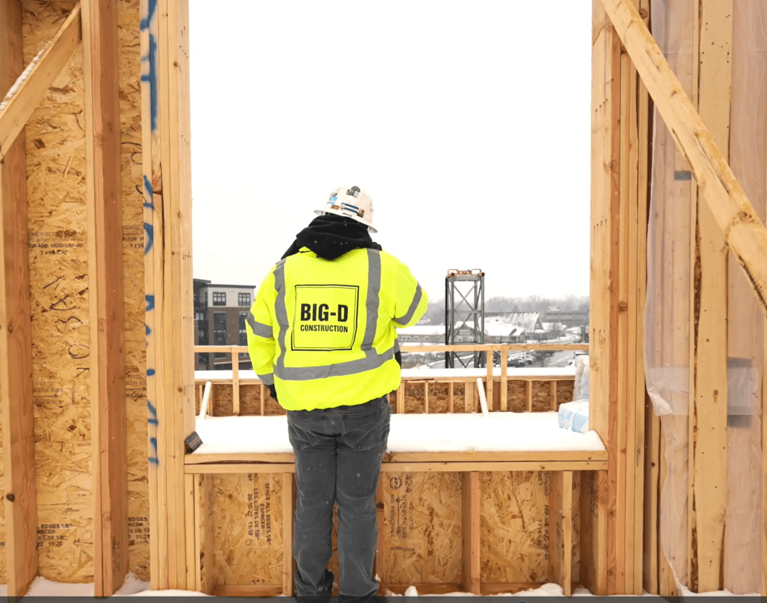 Big-D Construction Superintendent supervising through a window on a jobsite.